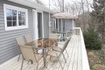 Large deck with outdoor tables and chairs